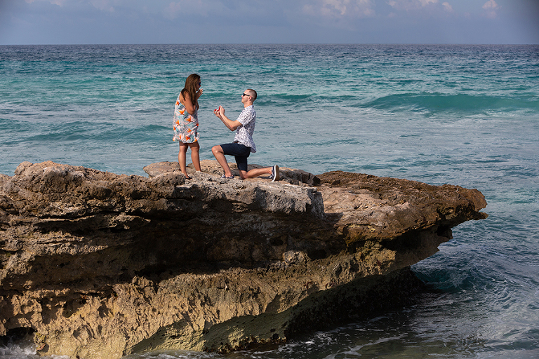 Secret marriage proposal on rock over the ocean on Isla Mujeres, Mexico.